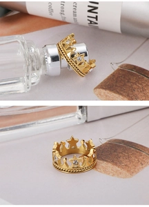 Detail of gold crown ring featuring hollow stars with zircons and twisted cable edges