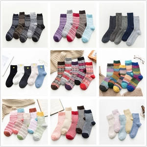 Collection of thick winter socks with Nordic patterns, snowflakes, and warm knit textures