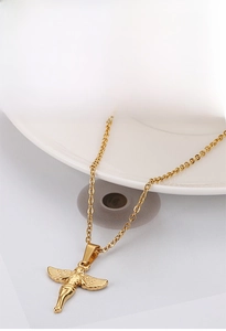 Close-up of golden angel pendant necklace in stainless steel with detailed wing textures