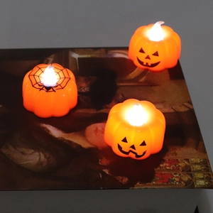 Set of 3 Halloween LED pumpkin candle lights with spider web patterns and warm yellow glow