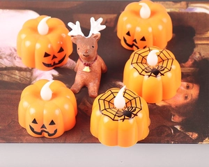 Detail of Halloween LED pumpkin candle lights with Jack-o'-lantern and spider web patterns