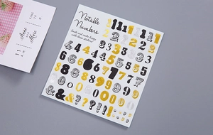 Detail of artistic gold and silver numeric stickers for DIY scrapbooking and planners