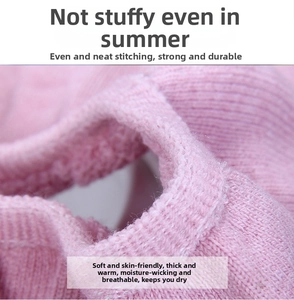 Detail of pink knitted toilet seat cover showing thick ribbed texture and soft fabric