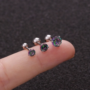 Close-up of three graded-size rainbow zircon stud earrings with screw backs on fingers