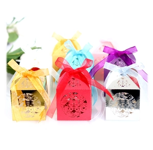 Hollow laser-cut Chinese wedding candy boxes in various colors with silk ribbons