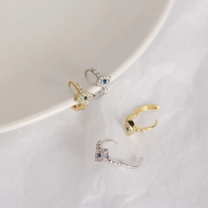 Detail of s925 silver evil eye hoop earrings with sparkling pave zircon stones