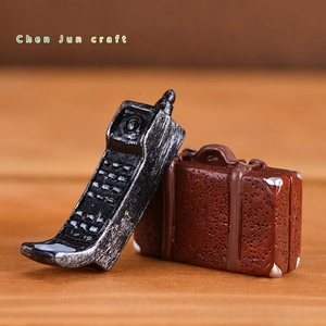 Miniature vintage resin phone and brown suitcase figurines for home decor and photography