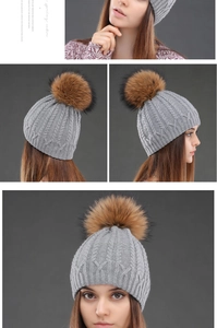 Detail of cable knit pattern and fluffy pom-pom on grey winter beanie for women