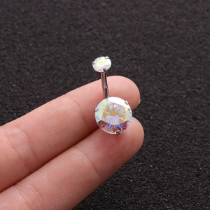 Close-up of sparkling colorful cubic zirconia and polished steel navel piercing jewelry