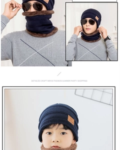 Detail of warm navy blue knitted hat with thick fleece lining and brown leather patch