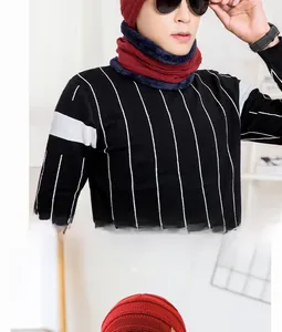 Detail of red winter knit beanie and neck warmer with thick fluffy navy fleece lining