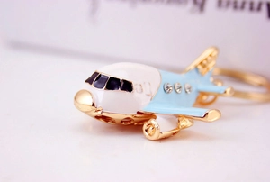 Detailed close-up of a helicopter keychain with blue enamel and sparkling rhinestones