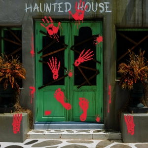 Detail of Halloween bloody handprint and footprint decals on a spooky haunted house door