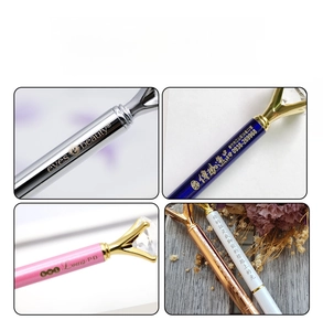 Detail of custom engraved metal diamond pens in silver blue and rose gold finishes
