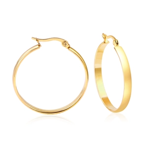 Close-up of polished gold circular hoop earrings showing detailed metallic texture