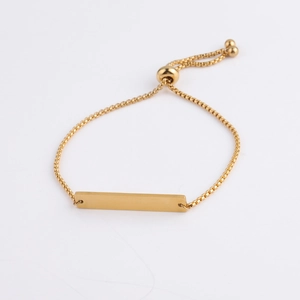 Detail of adjustable gold box chain bracelet with flat rectangular engraving bar