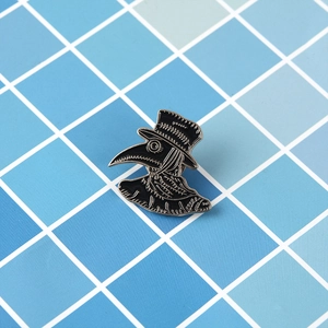 Detailed view of Plague Doctor enamel pin with black hat on blue checkered background