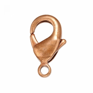 Macro shot of 18k gold plated copper lobster clasp with brushed metal texture details