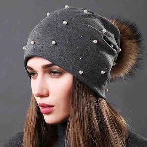 Grey knitted winter beanie with pearls, rhinestones and fluffy faux fur pom-pom