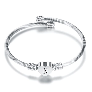 Stainless steel twisted wire open bangle featuring a polished silver heart charm with letter N