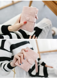 Pink matte finish short wallet for women featuring a wristlet strap and secure metal clasp