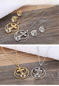 Detail of gold and silver cross hoop jewelry sets with zircon on dark wood