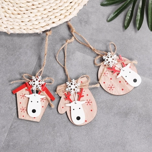 Three wooden Christmas ornaments featuring reindeer and snowflake designs on gray tile