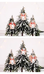 Detail of wooden Christmas ornaments featuring reindeer and snowflake patterns on pine tree