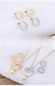 Detail of interlocking gold and silver circles with pavé crystals and pearl drops