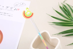 Close-up of cute flamingo and rainbow rubber charms on creative colorful gel pens