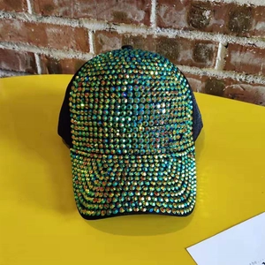 Detailed macro view of vibrant iridescent rhinestones on a stylish black baseball cap