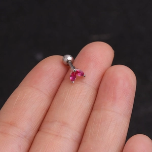 Macro shot of silver stainless steel stud earring with magenta marquise zircons