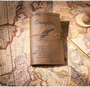 Detail of vintage leather journal featuring an engraved inspirational quote for fathers
