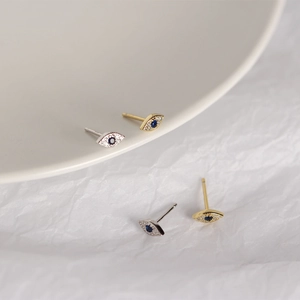 Detailed view of S925 sterling silver evil eye stud earrings with blue stones and crystals