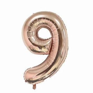 Detailed view of rose gold aluminum foil balloon shaped as number nine for parties