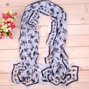 Classic pirate skull print long chiffon scarf in black and white on a wooden background