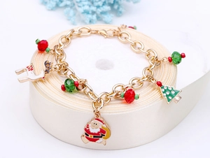 Detailed view of Christmas charm bracelet with Santa and reindeer on cream ribbon