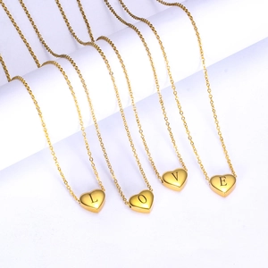 Golden heart pendant necklace featuring L-O-V-E laser engraving on a delicate chain
