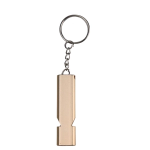 Detail of a matte gold aluminum alloy survival whistle with keychain ring on white background