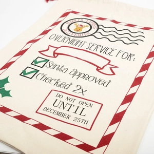 Detail shot of Rudolph Express printed pattern on textured canvas drawstring gift bag