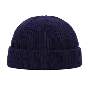 Detailed close-up of navy blue knitted texture and rolled cuff on this winter beanie