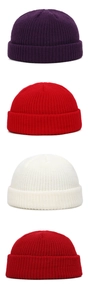 Detail view of colorful ribbed knit dockers caps in purple, red, and beige colors