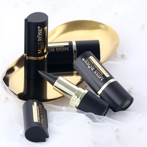Close-up of black long-wear gel eyeliners with gold accents on a decorative tray