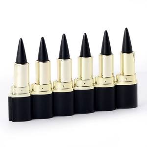 Row of six black and gold lipstick tubes with bullet caps on a clean white background