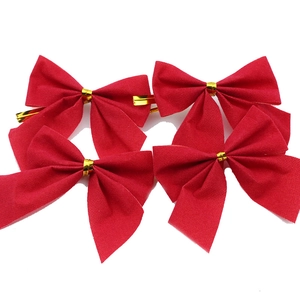 Set of four red velvet Christmas bows with gold ties for tree and gift decoration