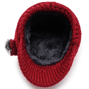 Red knit winter hat with thick faux fur lining and plush side pom-pom for warmth