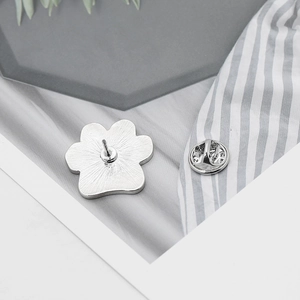 Detail view of silver paw print brooch back with secure butterfly clutch pin