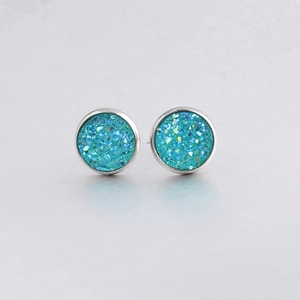 Detail of 10mm teal drusy stud earrings with sparkling texture and silver metal frame