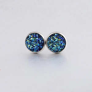 Macro shot of 10mm silver stud earrings with sparkling iridescent druzy blue stones