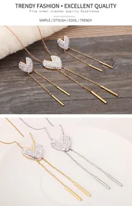 Detail view of heart-shaped crystal necklace and long fringe earrings in fine steel